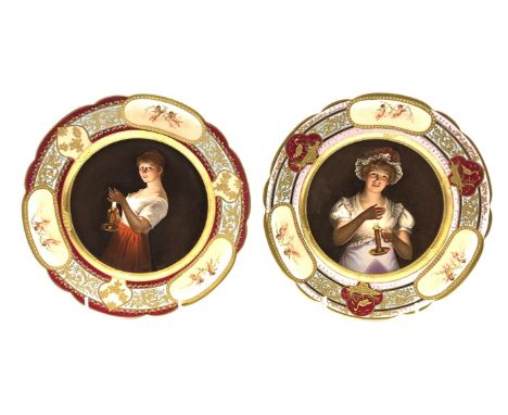 Pair of early 20th Century Vienna style porcelain plates each decorated with a female figure holding a candlestick and titled