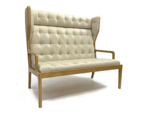 Contemporary light oak framed two seat wing back hall settee, upholstered in quilted beige leather, open arm rests, square ta