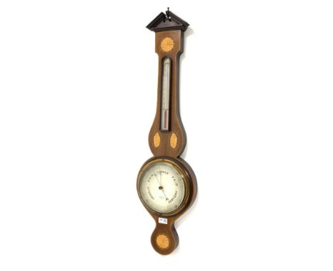 Edwardian aneroid wheel barometer in mahogany case, broken arch pediment above checker board edge and inlaid boxwood shell mo