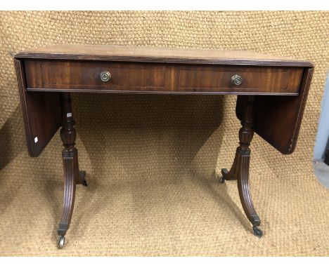 A Regency string inlaid and cross banded mahogany sofa table