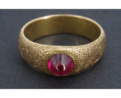 An Imperial Russian 56 Zolotnik standard (14 ct) yellow metal and ruby cabochon ring, the subtly pointed stone of approximate