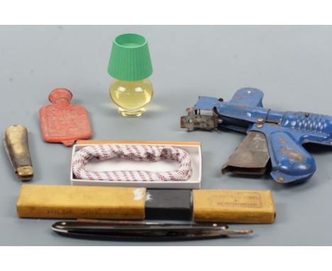 Collectors' items comprising a vintage tradesman's sample or toy Fairylite hot water bottle, a boxed pair of shirt sleeve gar