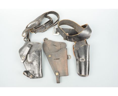 Two US Army leather shoulder holsters and a Western pistol belt