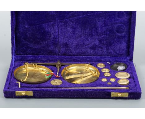 A cased set of brass beam scales and weights, late 20th Century, 26 x 14 x 3 cm
