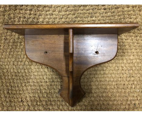 A mahogany bracket shelf