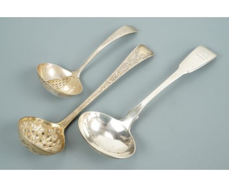 Silver straining and sifting spoons together with a sauce ladle