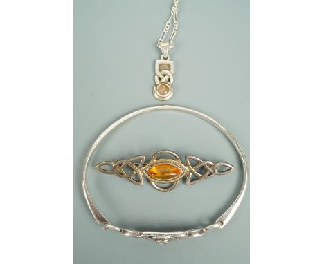 Contemporary Celtic-influenced silver and white metal jewellery comprising a bangle, brooch and pendant necklace