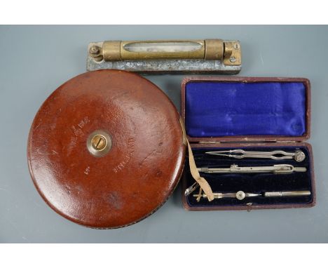 A vintage Treble brand tape measure, spirit level and drawing instruments 