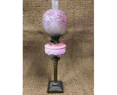 A Victorian brass columnar oil lamp with pink reservoir, 72 cm high