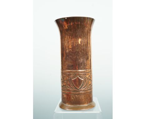 A Keswick School of Industrial Arts planished copper vase, of cylindrical form, with an everted rim and flared foot, decorate