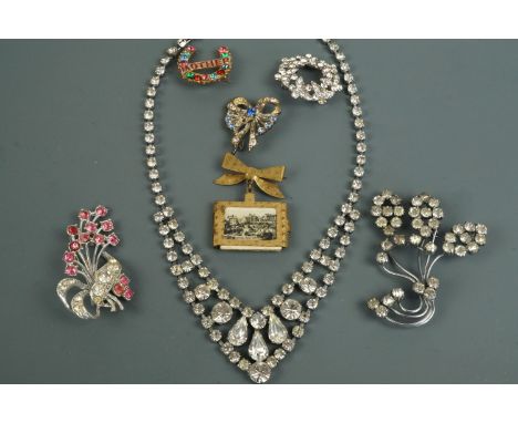 A group of vintage diamante and paste costume jewellery including a 1950s Yorkshire resort souvenir photobook brooch 