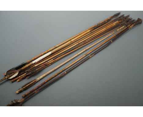 A collection of antique bamboo arrows, including examples with bodkin and variously barbed heads, and one birding arrow