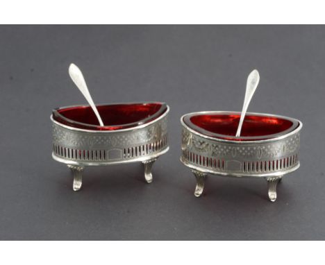 A pair of Georgian-influenced silver table salts and spoons, each of navette form, decorated with an engraved band of swags a