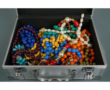 A flight case style jewellery box containing a quantity of vintage and contemporary costume jewellery