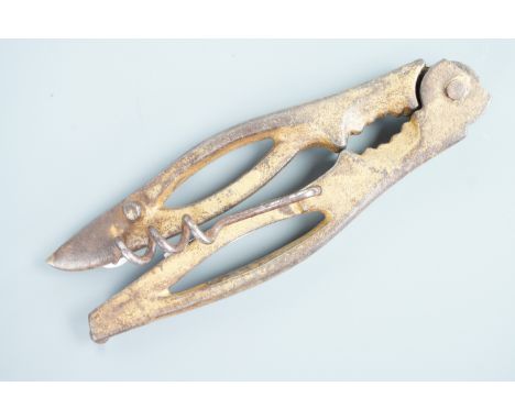 A 19th Century American cast-iron combination tool incorporating a nut cracker and corkscrew