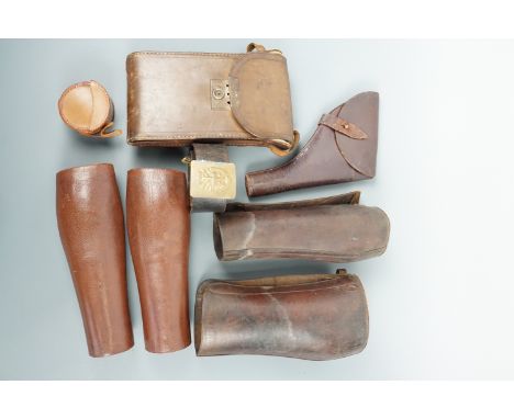 Military and other leather accoutrements including a Sam Browne revolver holster, gaiters, an Ordnance stamped and 1917 dated