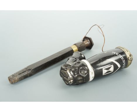 A late 19th / early 20th Century German porcelain and horn Memento Mori pipe, the bowl and stem socket modelled as a hand cla