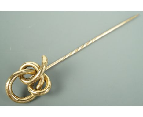 A Victorian yellow metal stick pin, its terminal in the form of an open knot, 9.5 cm, 6.2 g