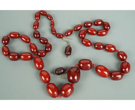 A vintage cherry amber coloured bead necklace and ear pendants
