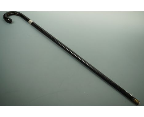 A late 19th / early 20th Century ebonized sword stick, having a hollow-ground triangular-section blade, bearing a white metal