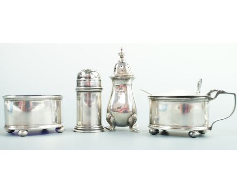 A George V silver condiment set, each item of oval section and comprising a salt cellar, mustard pot and pepperette, Deakin &