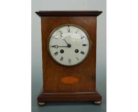 A late 19th Century French mantle clock, 30 hour stringing on a coil, having a white enamelled dial, and a string and marquet