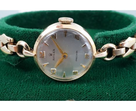 A 1950s lady's Rolex 9 ct gold wristlet watch, having a Precision movement and frosted silver face with gold Arabic numerals 