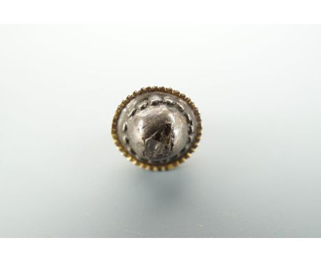 A small octahedral diamond screw-post earring, mounted in yellow and white metal, 8 mm diameter overall