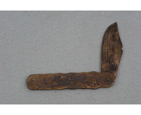 An antique Chinese or Chinoiserie folding knife, the grip scales embossed in depiction of dragons, 17 cm open