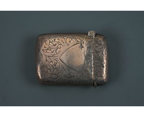 An Edwardian silver Vesta case, of cushion form, foliate-scroll engraved, one face centred by a vacant shield-shaped cartouch