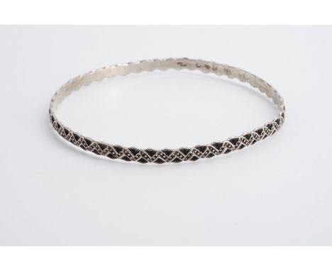 A Victorian Charles Horner Aesthetic movement influenced silver bangle, comprising pelleted chevrons facing textured concave 