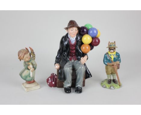A Royal Doulton figure of The Balloon Man 19cm high, a Royal Doulton Bunnykins figure of a Scout Leader 13cm high, and a Goeb