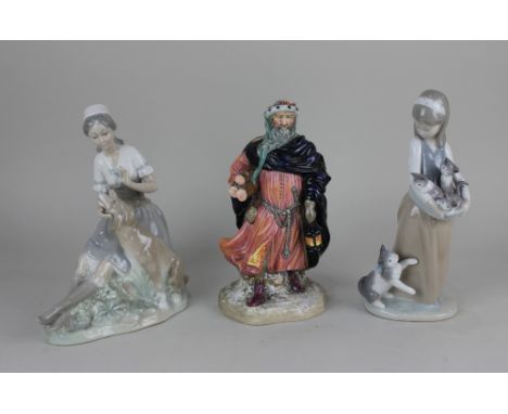 A Lladro porcelain figure of a girl with a cat and kittens 25cm high, a Nao porcelain figure of a seated girl with dog 21cm h