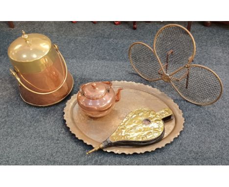 A collection of copper and brass ware comprising a brass clove shaped fireguard, copper and brass coal scuttle with cover, co
