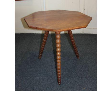 A mahogany occasional  'Cricket' table with hexagonal top on three sloping bobbin turned supports, 60cm