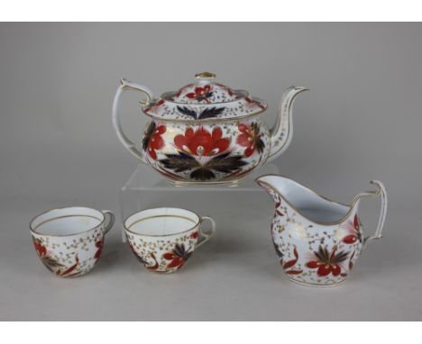 A Chamberlains Worcester porcelain teapot, milk jug and two tea cups, pattern 550, with floral decoration in rust, blue and g