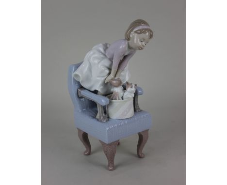 A Lladro porcelain 1998 event figurine of a young girl standing on a chair with kittens, 24cm high, boxed