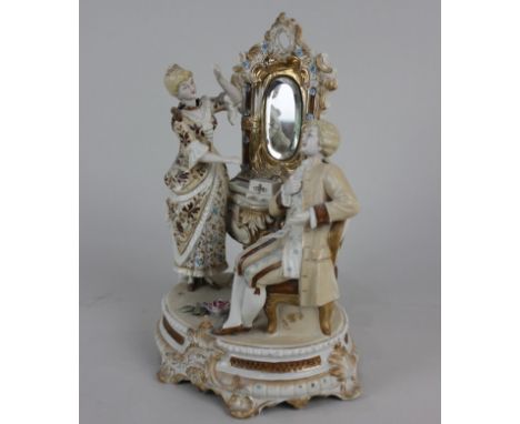 A Continental ceramic nodding figure group of a couple before a dressing table, 25.5cm high