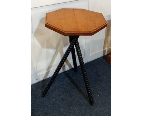 A pine occasional table with octagonal top on three sloping bobbin turned supports, 41cm