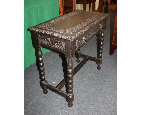 A carved rectangular side table with single drawer on bobbin turned supports and low uniting stretcher, 76cm