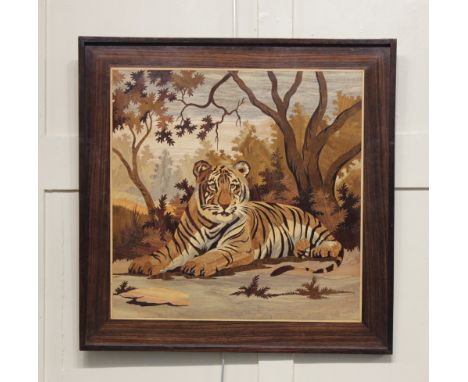 A marquetry wall panel inlaid with a tiger amongst trees 63cm by 63cm including integral frame