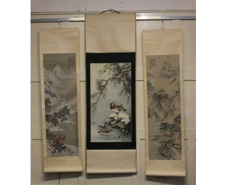 Three Chinese scrolls, to include one decorated with a mountainous snow covered landscape, top right with calligraphy and sea