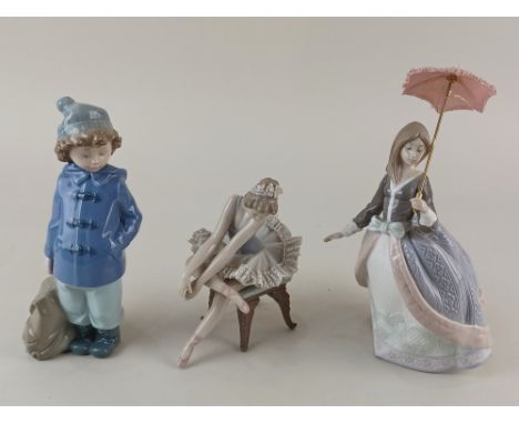 Two Lladro porcelain figures of a ballerina seated on a stool 14cm high, and a lady with a parasol approx 23cm high, together