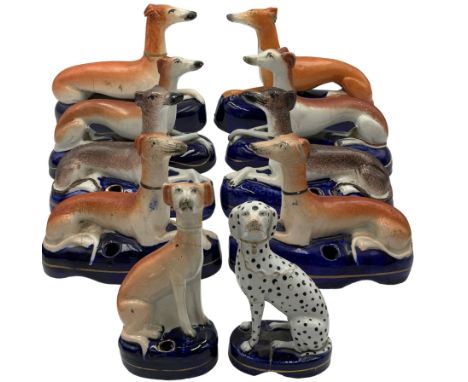 Group of 19th century Staffordshire inkwells, eight modelled as recumbent Greyhounds, two with sponged decoration, all on blu