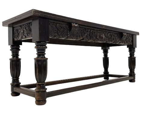 17th to 18th century oak refectory table, rectangular fold-over top over the frieze rail carved with a central cartouche with