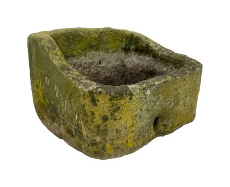 Weathered sandstone trough, sloped form with roughly tooled exterior and deeply hewn centreDimensions: Height:&nbsp;39cm&nbsp