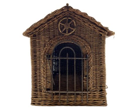 Early 20th century English wicker work animal carrier or kennel, of architectural form with pitched roof, arched doorway with