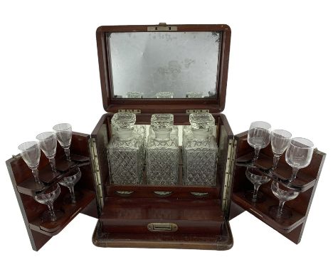 Edwardian mahogany decanter box, the mahogany banding strung with ebony, the hinged cover with internal mirror inset, set ove