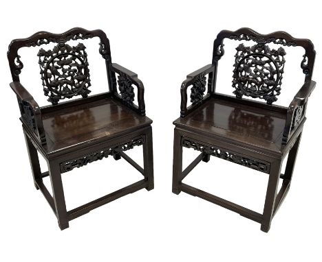 Pair of early 20th century Chinese carved hardwood armchairs, the shaped cresting rail with scroll decoration, the back pierc