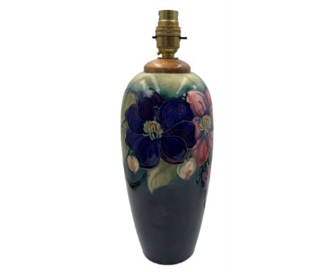 Moorcroft Clematis pattern table lamp, of ovoid form with graduated turquoise and blue ground, impressed 'Potter to H.M The Q